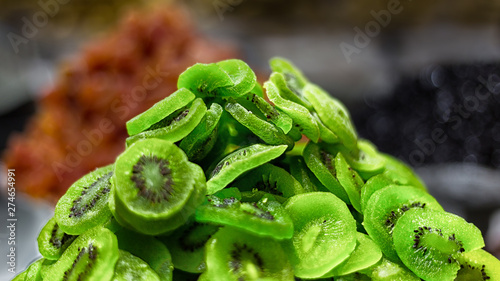 A heap of dried kiwi slices at a market stall in Spain. The green kiwi looks delicious and tastes sweet.