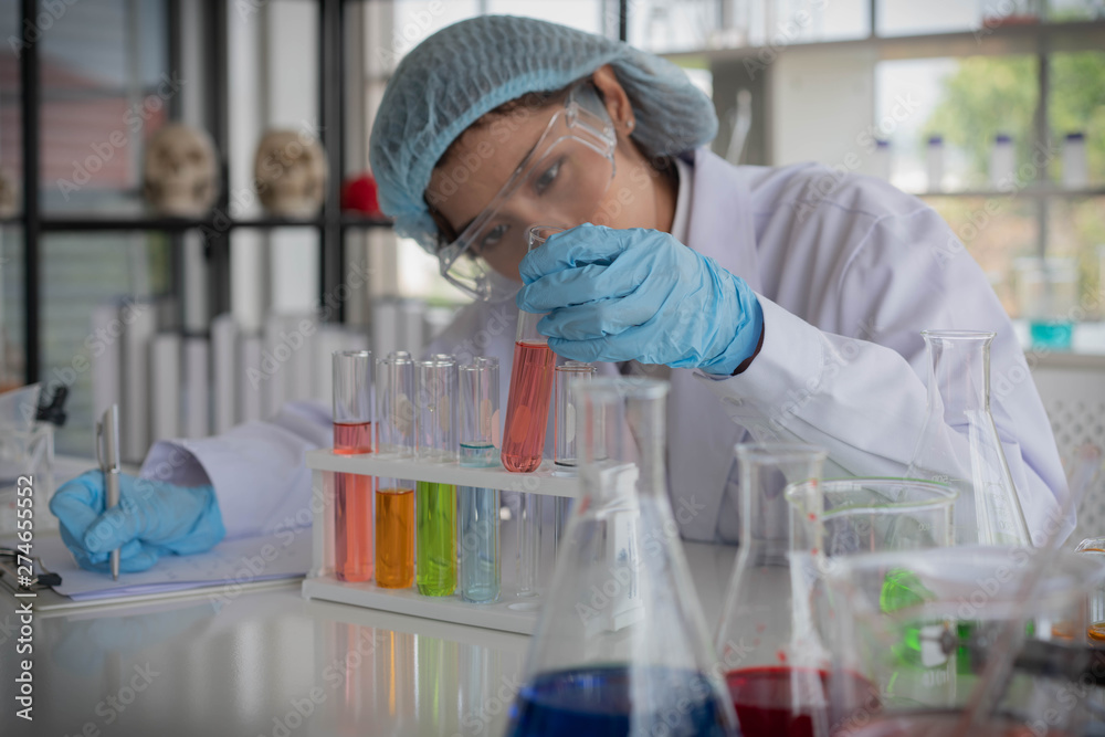 young asia female scientist trial chemical experiment by test tube and intrument in laboratory