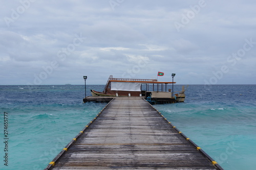 Traditional boat at a wooden pier in the Maldives