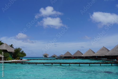 Water villas, sky and turquoise ocean on a clear sunny day © Talulla