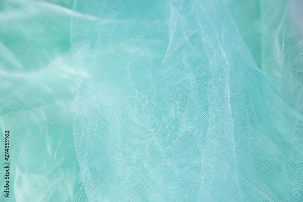 Textile and texture concept - close up of crumpled silk blue wavy fabric background with copy space for text or image Textile and texture concept - close up of crumpled silk blue wavy fabric background with copy space for text or image