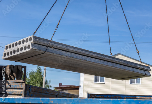 A crane raised a concrete slab at a construction site at home