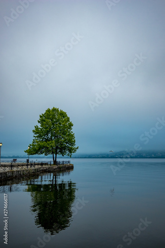 Tableau sur toile Ioannina, Greece, lake misty early spring morning with fog over the lake Pamvotida calm waters