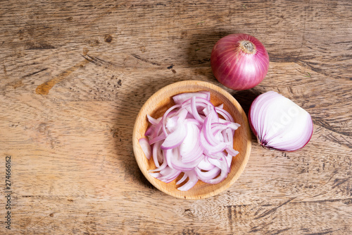 Fresh red onion on wooden background