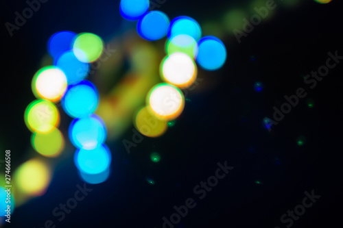 Duotone green and blue spiral of blurry neon lights. Abstract background of 80s colors