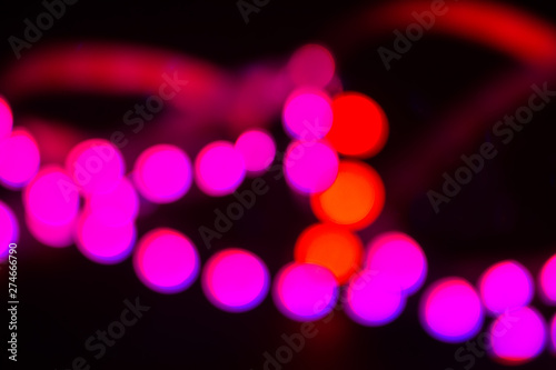 Duotone Red and purple neon lights on black. Abstract blurred background photo