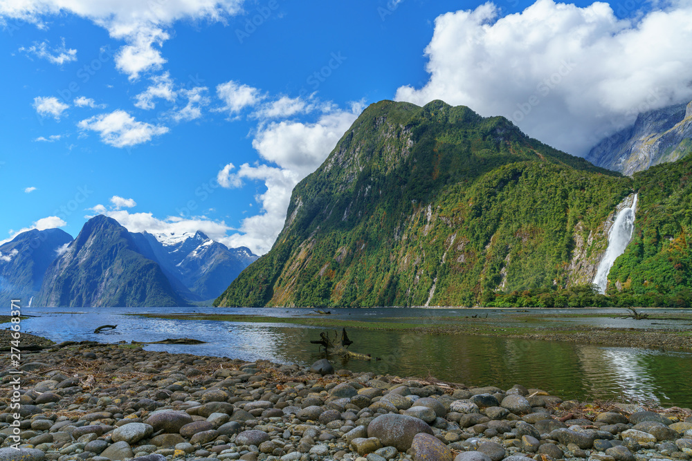 reflections of mountains and a waterfall, milford sound, new zealand 4