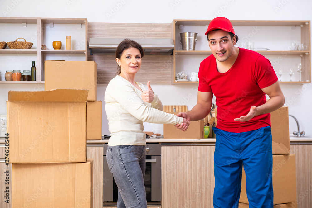 Young male contractor and female customer in moving concept Young male contractor and female customer in moving concept
