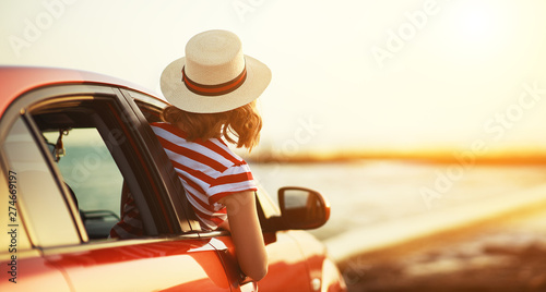 Obraz na plátne happy woman girl goes to summer travel trip in   car.