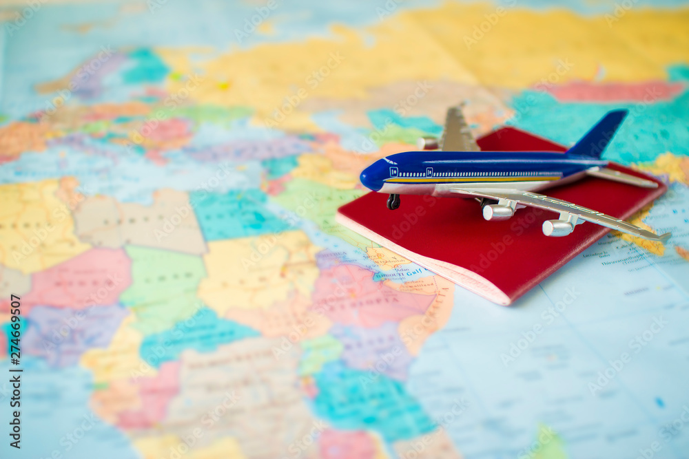 toy aircraft and neutral passport on the world map. travel and air transportation concept, flight to africa, trip by plane, booking flights toy aircraft and neutral passport on the world map. travel and air transportation concept, flight to africa, trip by plane, booking flights