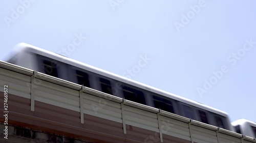 Low angle view as a city passenger train passes left to right on an elevated track system.with copy space for text 