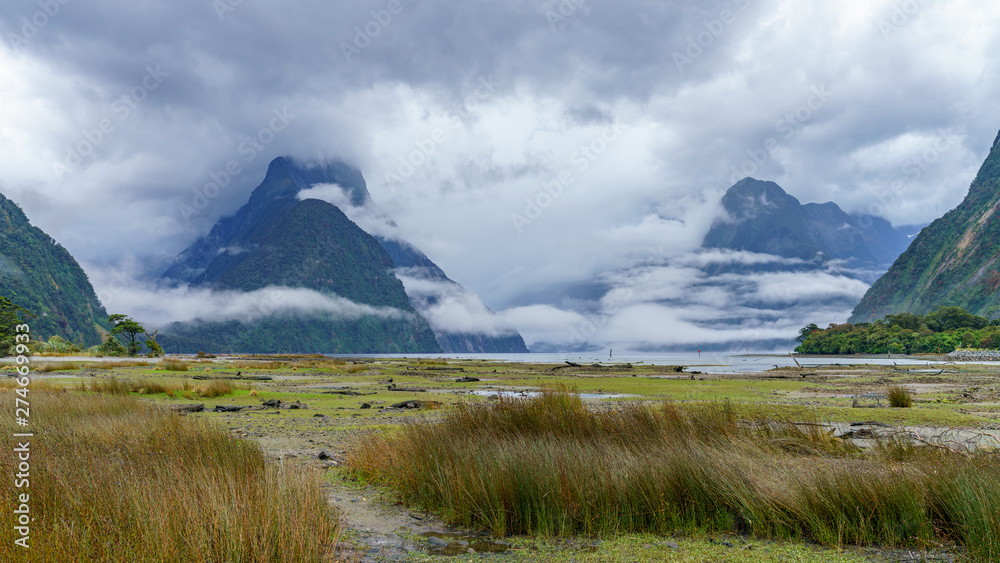 cloud shrouded peaks at famous natural wonder milford sound, new zealand 8