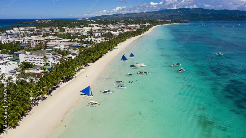 Crowds of people and boats around a beautiful, busy tropical beach (White Beach, Boracay, Philippines) Crowds of people and boats around a beautiful, busy tropical beach (White Beach, Boracay, Philippines)