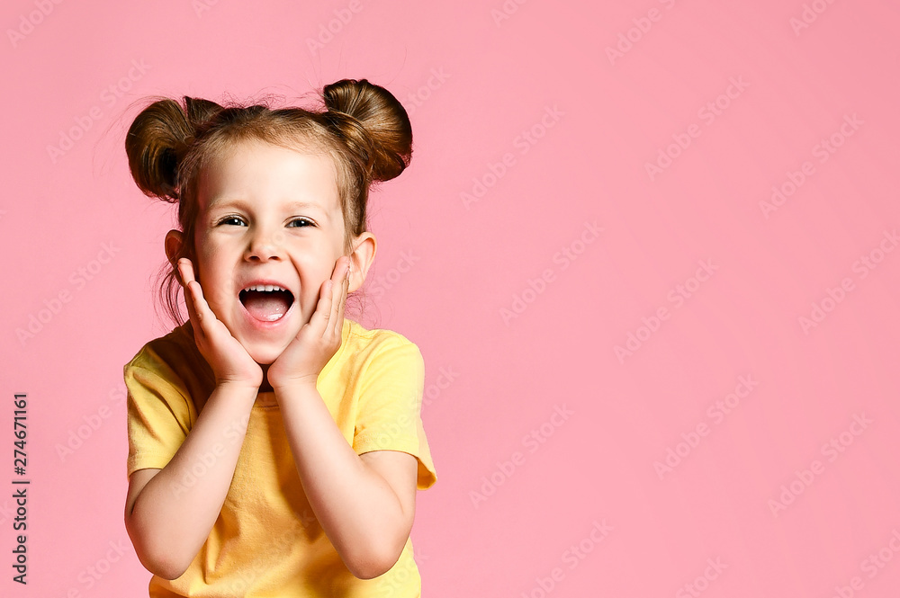 Portrait of little girl holding hands on head, screaming with opened mouth and crazy expression. Surprised or shocked face Portrait of little girl holding hands on head, screaming with opened mouth and crazy expression. Surprised or shocked face