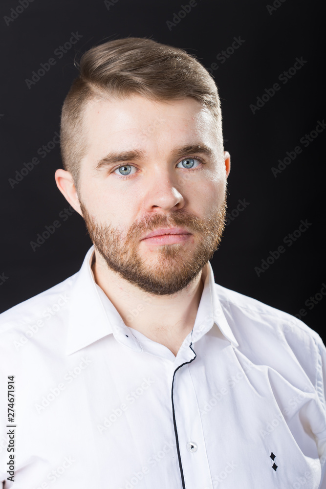 Portrait, guy and business people concept - Handsome serious man in white shirt looking at camera Portrait, guy and business people concept - Handsome serious man in white shirt looking at camera