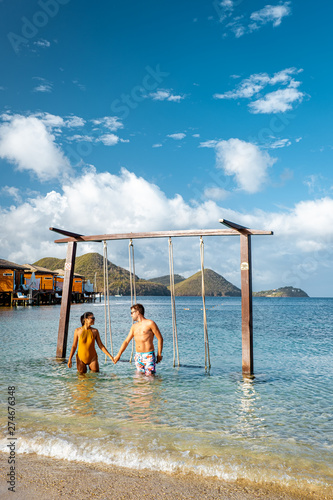 couple on luxury vatation at the tropical Island of Saint Lucia, men and woman by the beach and crystal clear ocean of St Lucia Caribbean Holliday photo