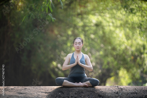 Woman practice yoga with nature background