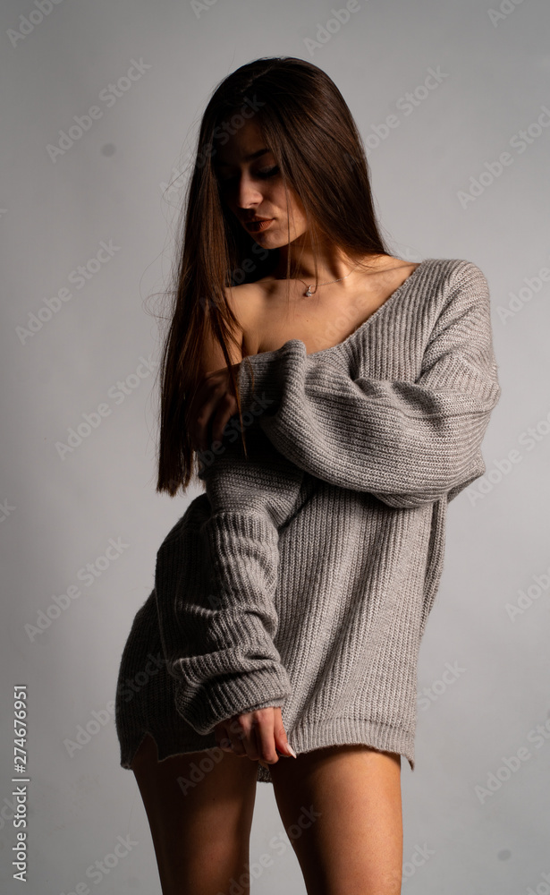 Fototapeta premium beautiful sexy girl, posing gray dress, white background