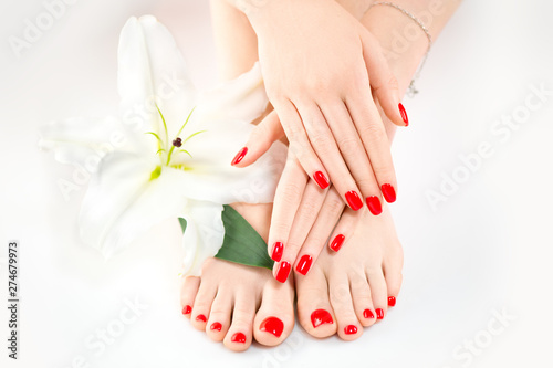 Manicure and pedicure in spa salon. Skincare concept. Healthy female hands and legs with beautiful nails