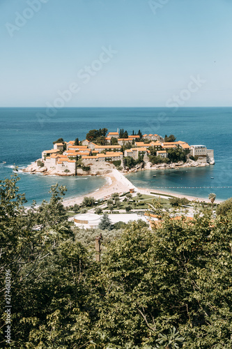 Atmospheric tourist views of the old town from the mountain. The picturesque coast of the island of Sveti Stefan.