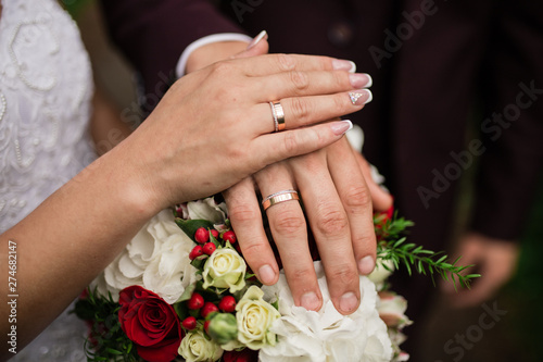 Hands of the bride and groom with wedding rings. Wedding day young