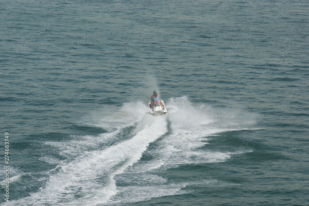 jet ski riders. man and woman ride a jet ski