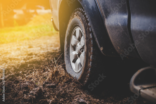 Close-up car tires are dirty on the mud. © Sumala