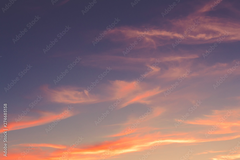 Sunset sky background. Dramatic sunset sky with evening sky clouds lit by bright sunlight - natural landscape view.