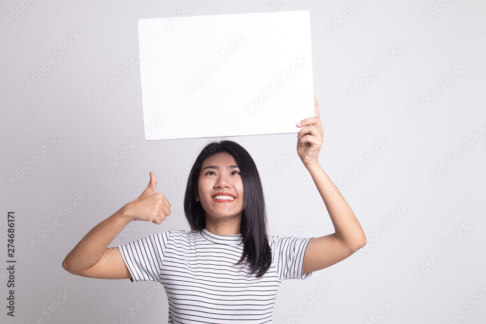 Young Asian woman show thumbs up with white blank sign. Young Asian woman show thumbs up with white blank sign.