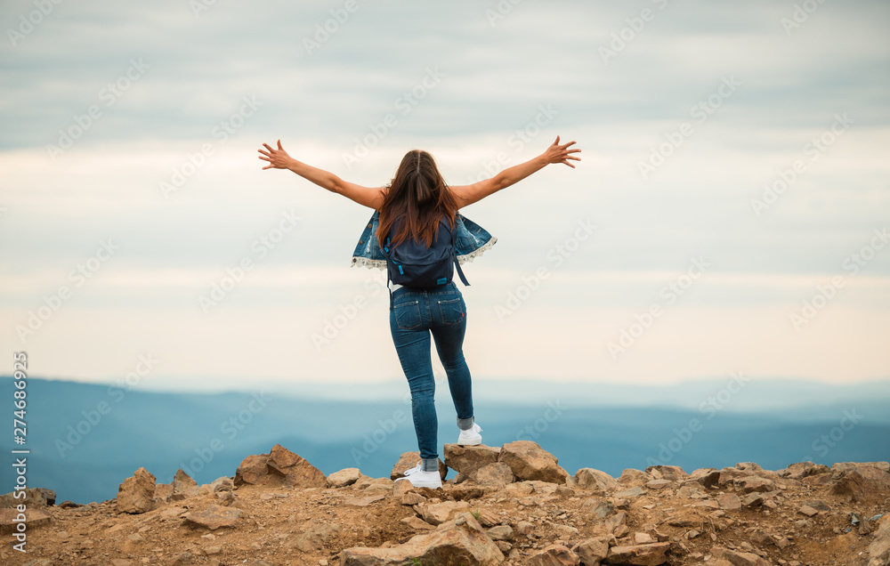 A healthy woman celebrates during a beautiful sunset. Happy and free. stand on the edge of the mountain. beautiful mountain. A healthy woman celebrates during a beautiful sunset. Happy and free. stand on the edge of the mountain. beautiful mountain.
