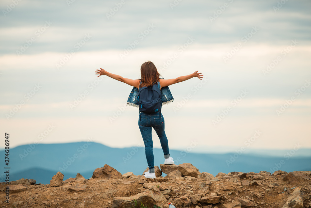 A healthy woman celebrates during a beautiful sunset. Happy and free. stand on the edge of the mountain. beautiful mountain. A healthy woman celebrates during a beautiful sunset. Happy and free. stand on the edge of the mountain. beautiful mountain.