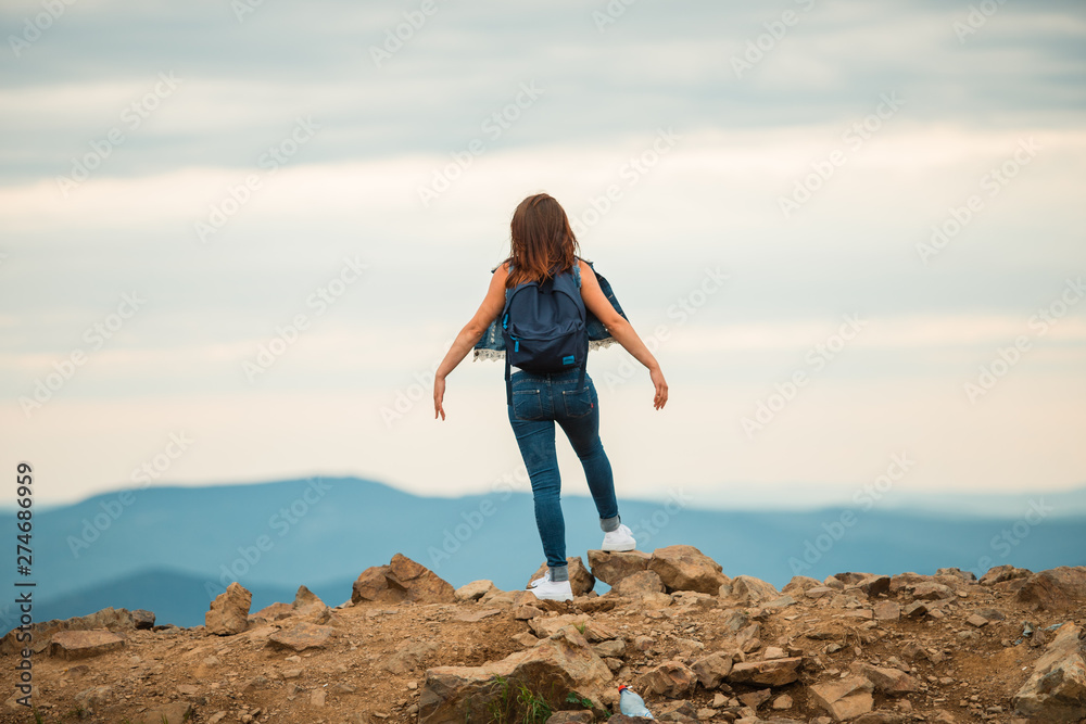 A healthy woman celebrates during a beautiful sunset. Happy and free. stand on the edge of the mountain. beautiful mountain. A healthy woman celebrates during a beautiful sunset. Happy and free. stand on the edge of the mountain. beautiful mountain.