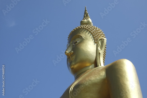 Statue of Buddha soaring into blue sky