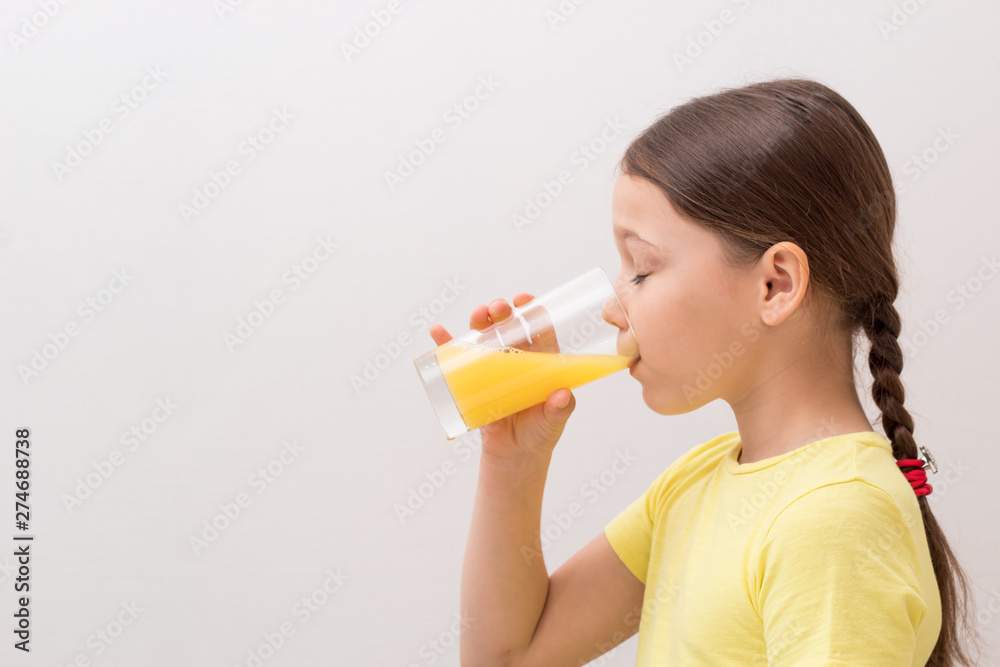 little girl drinks orange juice, a child enjoys a drink little girl drinks orange juice, a child enjoys a drink
