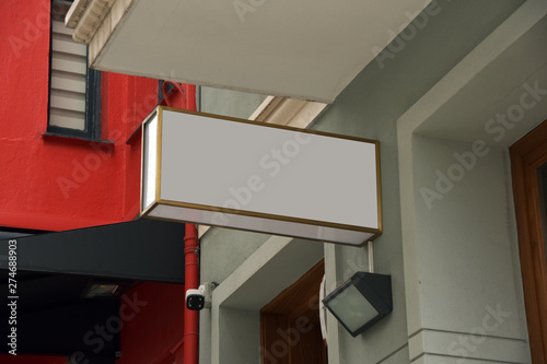 Empty white circle and blank square shop signboard layout. Lightbox attached to the wall on the street. Model. 3d render mockup signboard photo