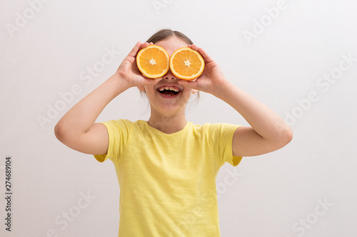 little girl with juicy oranges, baby playing with fruit