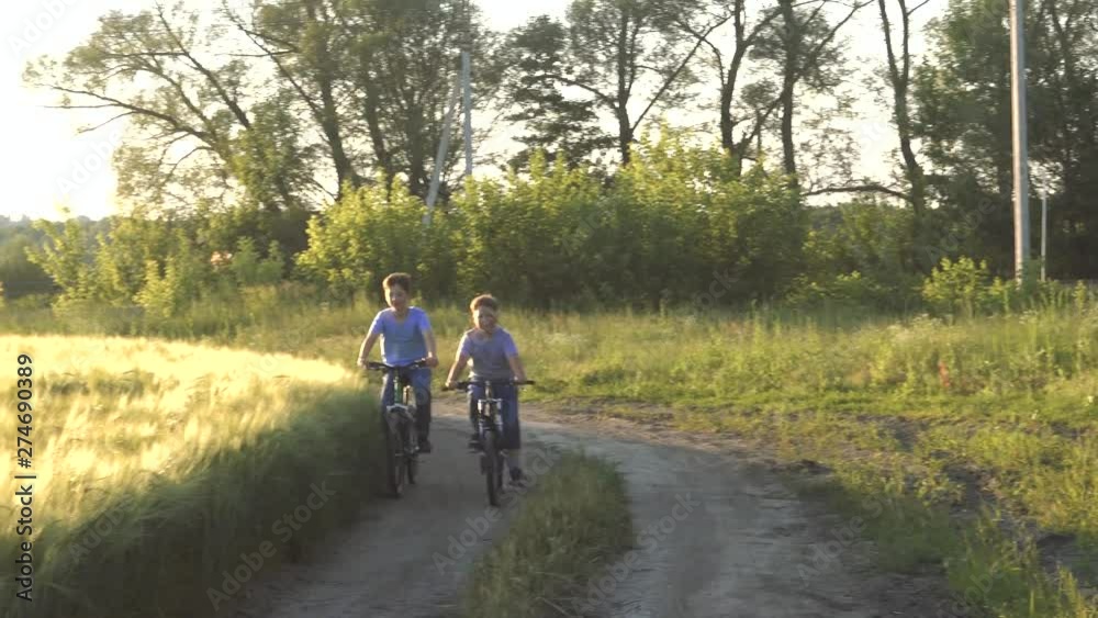 A boys is riding a bicycle. Child cycling. A teenage on a bike on a wheat field. A boys is riding a bicycle. Child cycling. A teenage on a bike on a wheat field.