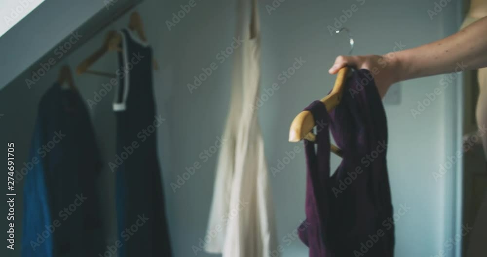 Young mother getting dressed with her toddler