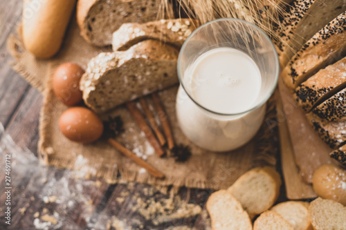 Top view milk in a glass bottle placed on a wooden table with ingredients