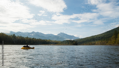 Rear view of kayaker people paddle a kayak in the sunset sea. Kayaks, canoes, Rowing. Boat © Dima