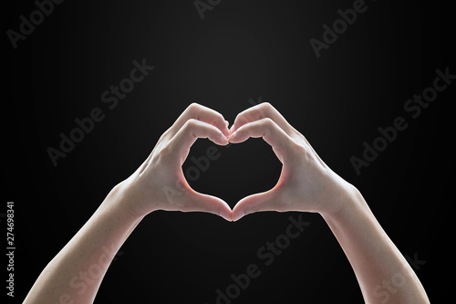 Woman hands in heart shape isolated on black background