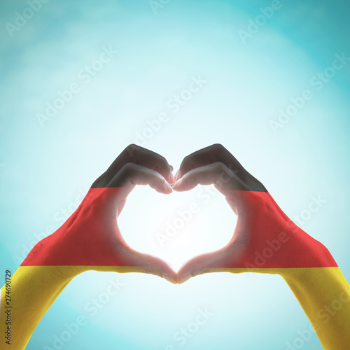 Germany national flag on people heart shape hands. photo