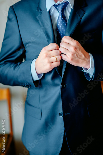 Man the groom in a wedding costume with butterfly. Hands, care, to correct, to adjust, fashion. Instagram colors toning