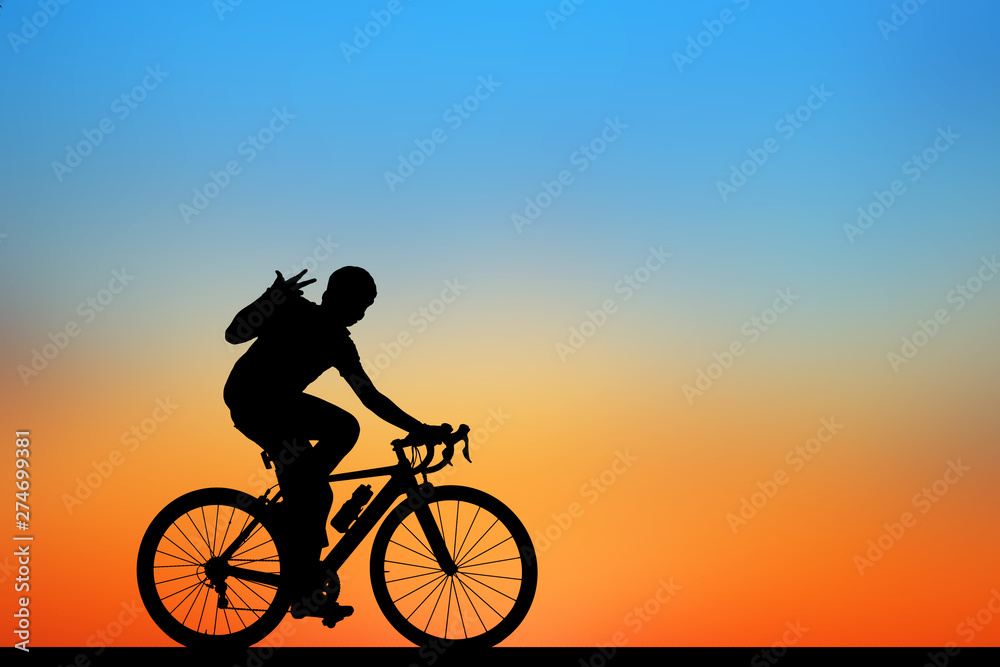 Silhouette man and bike relaxing on blurry sunrise sky background. Silhouette man and bike relaxing on blurry sunrise sky background.