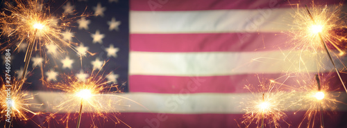Vintage Celebration With Sparklers And Defocused American Flag - 4th Of July photo