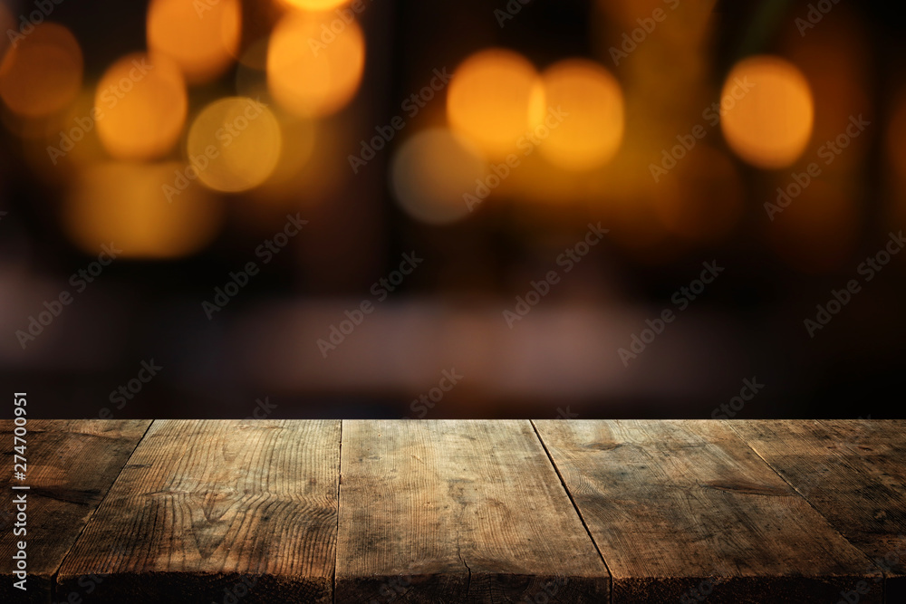 background of wooden table in front of abstract blurred restaurant lights background of wooden table in front of abstract blurred restaurant lights