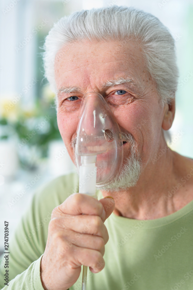 Close up portrait of ill senior man portrait with inhaler Close up portrait of ill senior man portrait with inhaler