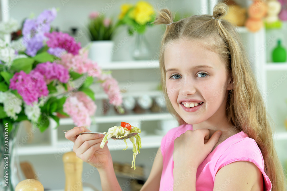 Portrait of cute girl eating delicious fresh salad Portrait of cute girl eating delicious fresh salad