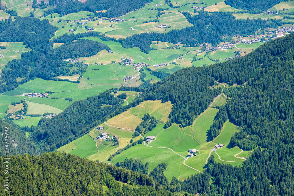 Aerial view of an alp valley with fields and farms
