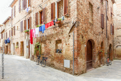 Italian alleyway with hanging laundry and parked bicycles